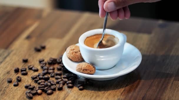 Donna mano tenendo cucchiaio da caffè per mescolare il caffè caldo sul tavolo da lavoro — Video Stock