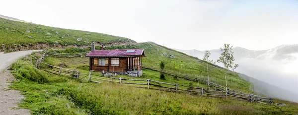 Traditional house at plateau with big fog — Stock Photo, Image