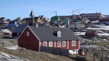 Grönland, Ilulissat 'ta renkli geleneksel evler. Bu ikonik ahşap evler dramatik bir kuzey manzarasına karşı kurulan Eskimo kültürünü ve Arktik yaşam tarzını yansıtıyor. Ilulissat Grönland 'ın en tanınmış şehirlerinden biridir.