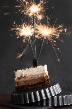 Parıltılı ışıkları olan bir parça kek, şenlikli kutlama konsepti.