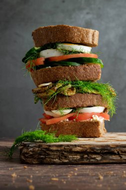 Tam buğday ekmekli ev yapımı sandviçler, krem keçi peyniri, yumurta, ızgara kabak ve çiğ dereotu.