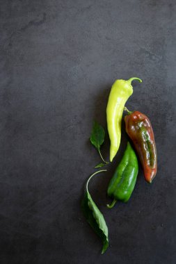 Karanlık arka planda çiğ biber, yemek arkaplanı. Sebze besin malzemeleri.