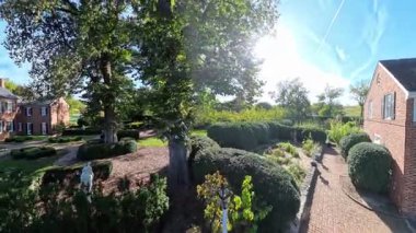 Experience the serene outdoors of Shenandoah Gardens in Winchester, Virginia. Enjoy views of the garden, museum, and surrounding landscape on a sunny day.