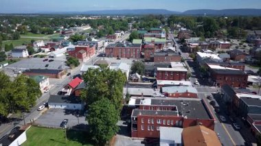 Experience the breathtaking hyperlapse aerial views of Charles Town, West Virginia. Enjoy summer landscapes showcasing lush greenery and charming neighborhoods.