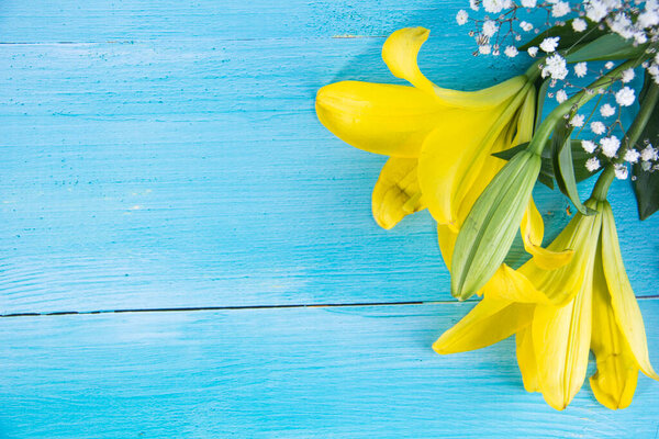Fresh spring yellow flowers on blue painted wooden
