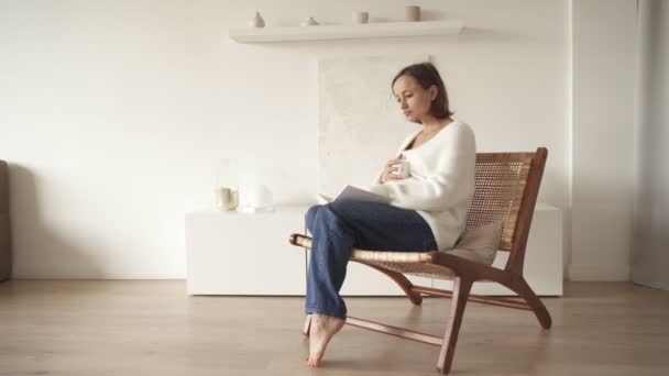 Hamile kadın kitap okuyor ve evde dinleniyor. — Stok video