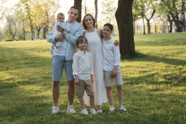 屋外で3人の子供と幸せな調和のとれた家族。公園内の家族の肖像画. — ストック写真