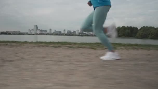 4K крупним планом нога біжить жінки носять кросівки починають бігати по дорозі. Жінки бігають на пляжі. жінка вправа біжить тренування на відкритому повітрі вранці . — стокове відео