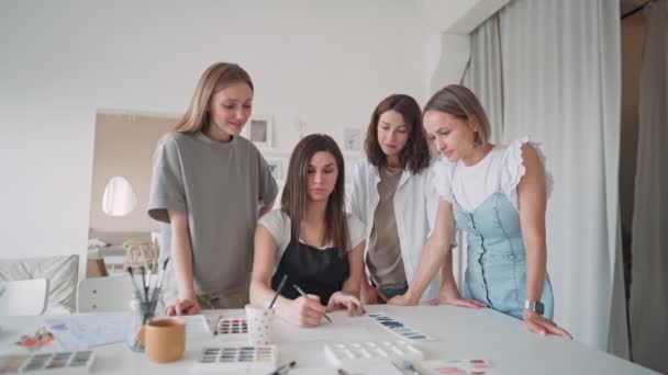 미술 작업실에 있는 네 명의 아름다운 코카서스 여성의 전경. 한 젊은 교사가 그림을 가르친다 — 비디오