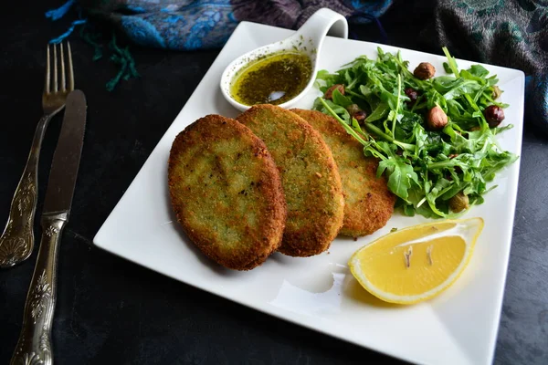 fried Cutlets with lemon and green salad