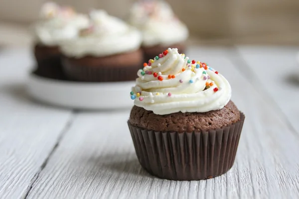 Chocolate cupcake with white frosting and decoration — Stock Photo, Image