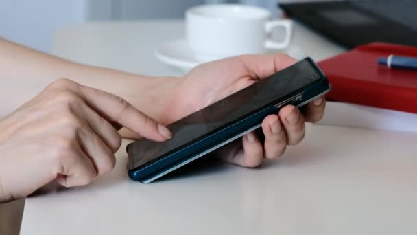 Hand of woman using smartphone, surfing internet or social media. Close-up, side view — Stock video
