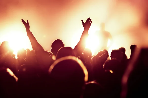 Silhouettes of concert crowd in front of bright stage lights Royalty Free Stock Photos