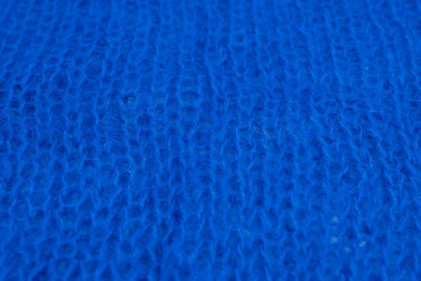 Yumuşak mavi yün kumaş dokusu ve detaylı lifler. Tasarım, moda ya da zanaat projeleri için samimi bir arka plan. Doğal dokuma ipliği desenli makro çekim.