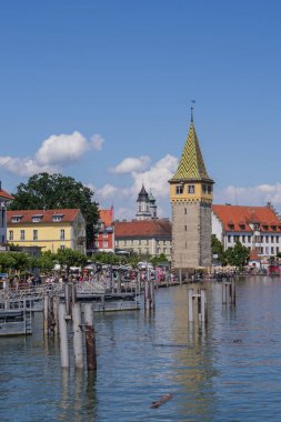 Lindau eski kasaba limanı Mangturm kulesi, gezinti güvertesi, tekneler ve güneşli bir günde sakin Constance Gölü suyu
