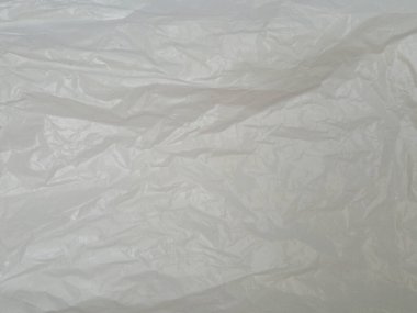White crumpled plastic bag texture background. Real High-Density Polyethylene shopping bag. HDPE shopper texture