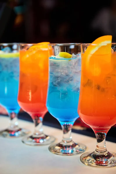 Multicolored alcoholic and non-alcoholic cocktails with ice