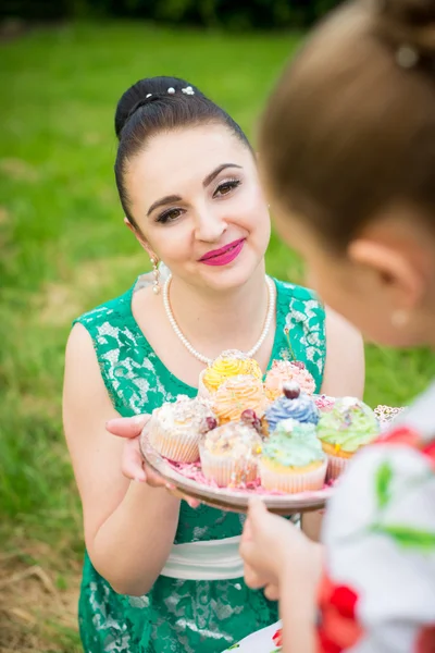 Mother and daughter cooking cupcakes