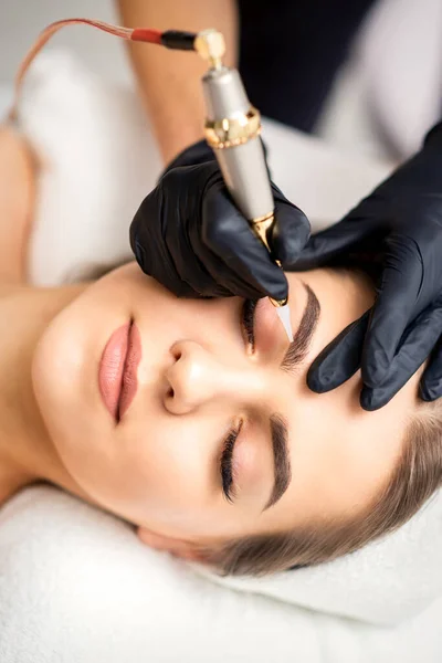 Beautician Applying Permanent Makeup Eyebrows Young Woman Special Tattoo Machine — Stock Photo, Image