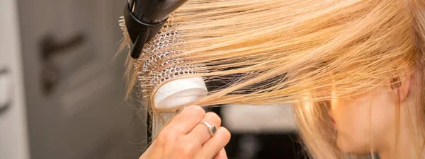 Zbliżenie Dłoni Fryzjera Suszenie Włosów Młodej Blondynki Salonie Fryzjerskim — Zdjęcie stockowe
