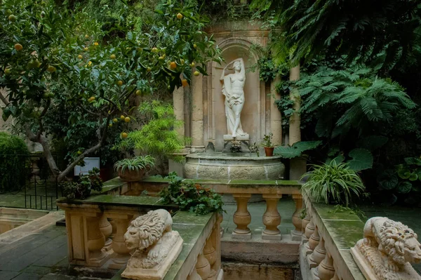 Female sculpture in a lemon garden