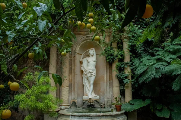 Female sculpture in a lemon garden