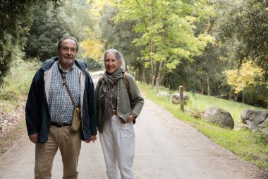 Bir çift dağ yolunda yürüyor açık hava aktivitelerinin tadını çıkarıyor.