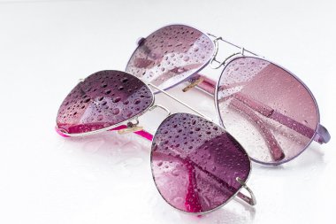 rose sunglasses and drops on an isolated background clipart