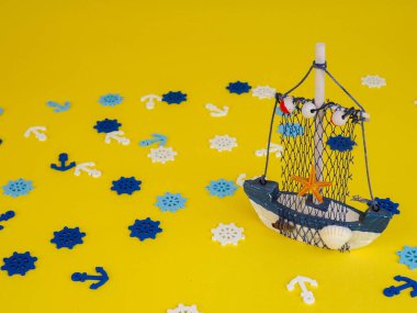 small boat on a yellow background, the concept of recreation and summer