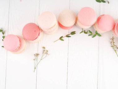 French colorful macaroons on white background. sweet multicolored French macarons cookies, selective focus