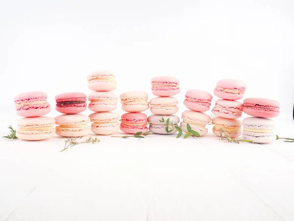 French colorful macaroons on white background. sweet multicolored French macarons cookies, selective focus — Stock Photo, Image