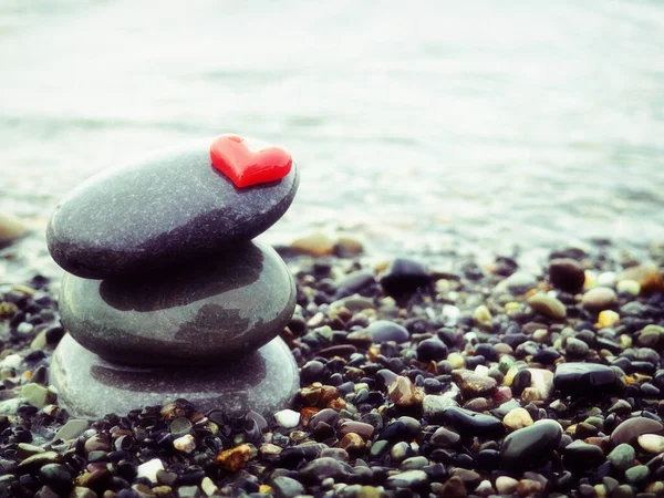 Stacked Zen stones with heart on sea background - Concept of love and balance — Stock Photo, Image