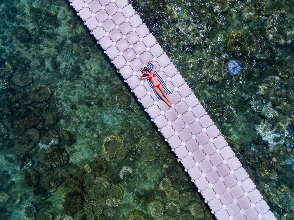 Woman on pontoon bridge aerial view — Stock Photo, Image