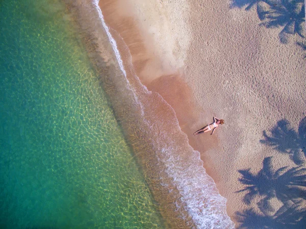 Girl on the beach by aerial view — Stock Photo, Image