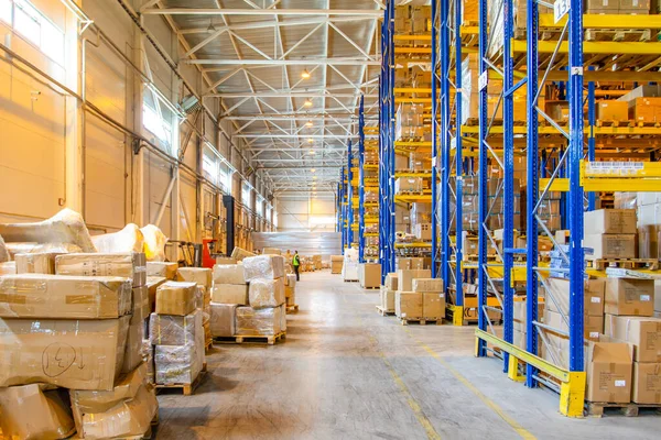 Interior of a modern warehouse storage with rows and goods boxes on high shelves