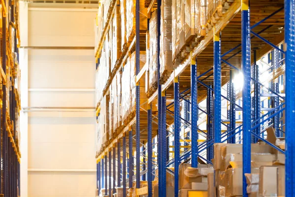 Interior of a modern warehouse storage with rows and goods boxes on high shelves