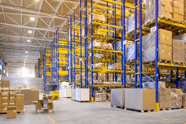 Interior of a modern warehouse storage with rows and goods boxes on high shelves