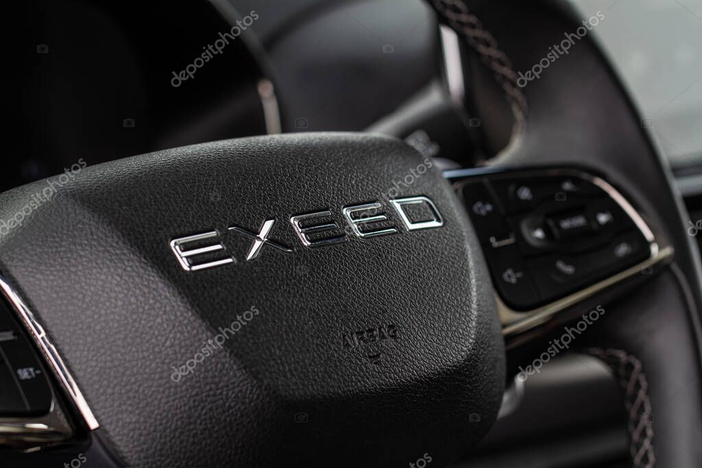 MOSCOW, RUSSIA - FEBRUARY 23, 2021 CHERYEXEED TXL SUV car dark interior close up view. Chery exeed logo on steering wheel close up view. Chery Exeed TXL / Vantas TXL.