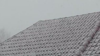 Kar yavaşça çatıyı kaplıyor.