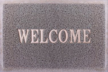 Welcome Door Mat Isolated. Friendly Grey Door Mat Closeup. Welcome Carpet. Foot Scraper Texture Background. clipart