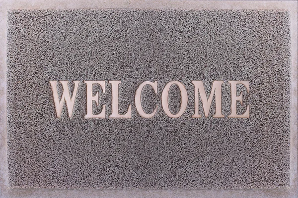 Welcome Door Mat Isolated. Friendly Grey Door Mat Closeup. Welcome Carpet. Foot Scraper Texture Background. — Stock Photo, Image