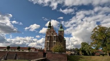Urban scene in Copenhagen city centre captures Nyhavn canal lined with 17th century buildings, bicycles parked along the waterfront, and people strolling in the afternoon light