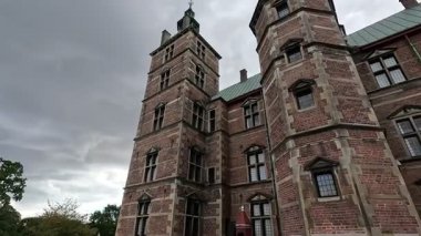 Urban scene in Copenhagen city centre captures Nyhavn canal lined with 17th century buildings, bicycles parked along the waterfront, and people strolling in the afternoon light