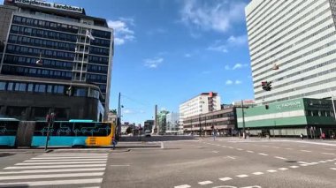 Urban scene in Copenhagen city centre captures Nyhavn canal lined with 17th century buildings, bicycles parked along the waterfront, and people strolling in the afternoon light