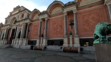 Urban scene in Copenhagen city centre captures Nyhavn canal lined with 17th century buildings, bicycles parked along the waterfront, and people strolling in the afternoon light