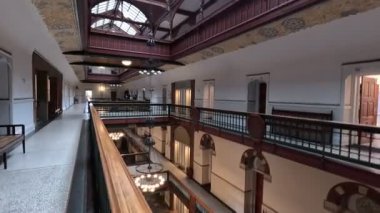 Urban scene in Copenhagen city centre captures Nyhavn canal lined with 17th century buildings, bicycles parked along the waterfront, and people strolling in the afternoon light