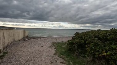 Views of quaint buildings with pitched roofs line the streets of Raa, Sweden's historic fishing village, with calm docks extending into the Oresund waters near Helsingborg.