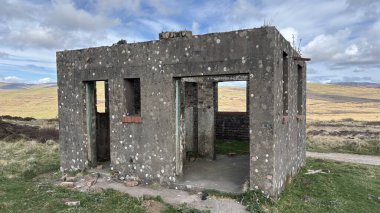 Countryside landscape near Milquhanzie Hill in Perth and Kinross Scotland showing ridge summit with masts, walking paths, and nearby ancient standing stones.