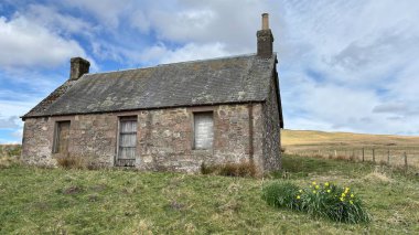 Countryside landscape near Milquhanzie Hill in Perth and Kinross Scotland showing ridge summit with masts, walking paths, and nearby ancient standing stones.