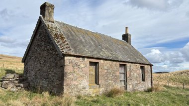 Countryside landscape near Milquhanzie Hill in Perth and Kinross Scotland showing ridge summit with masts, walking paths, and nearby ancient standing stones.